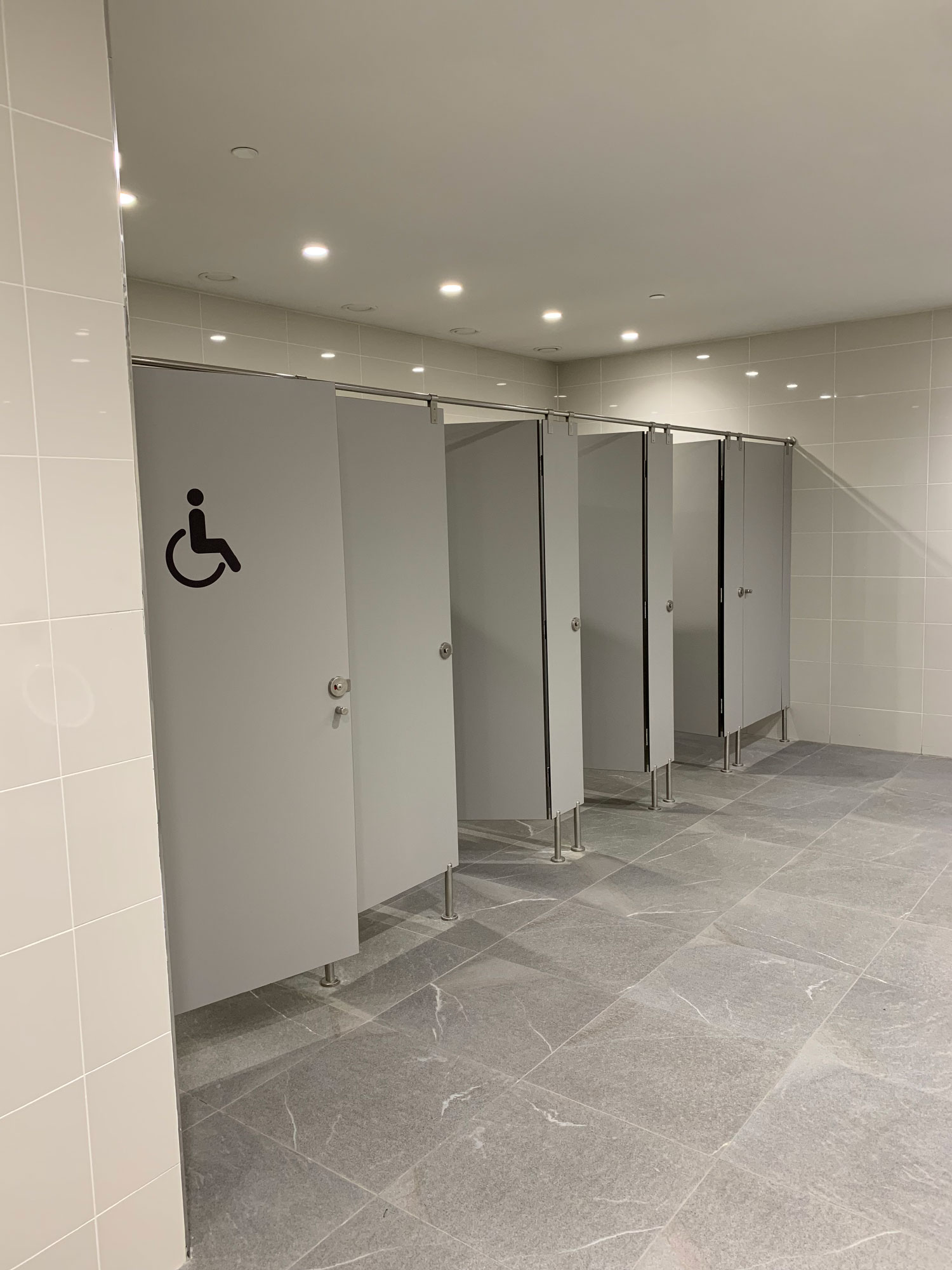 Airport bathroom partitions with Fundermax phenolic panels